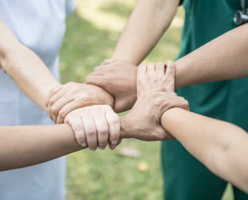 Doctors and nurses coordinate hands