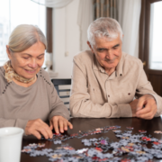 a senior couple doing a puzzle
